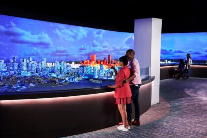 Visitors enjoying the indoor observation deck with Boston skyline views