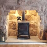 Wood stove in a fireplace with warm accent lighting
