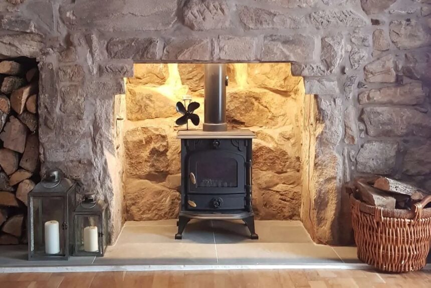 Wood stove in a fireplace with warm accent lighting