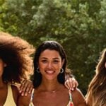 Three women smiling in Bravissimo cup-sized swimwear