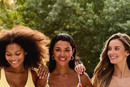 Three women smiling in Bravissimo cup-sized swimwear