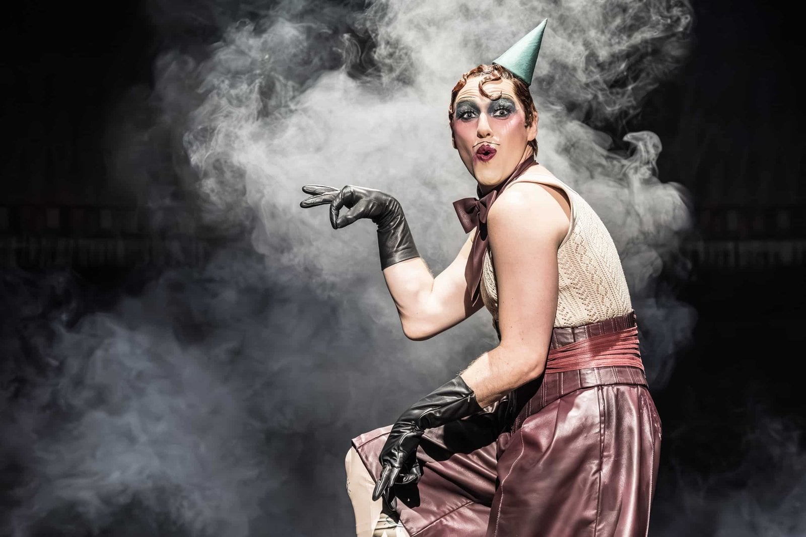 Cabaret performer posing in smoke on stage