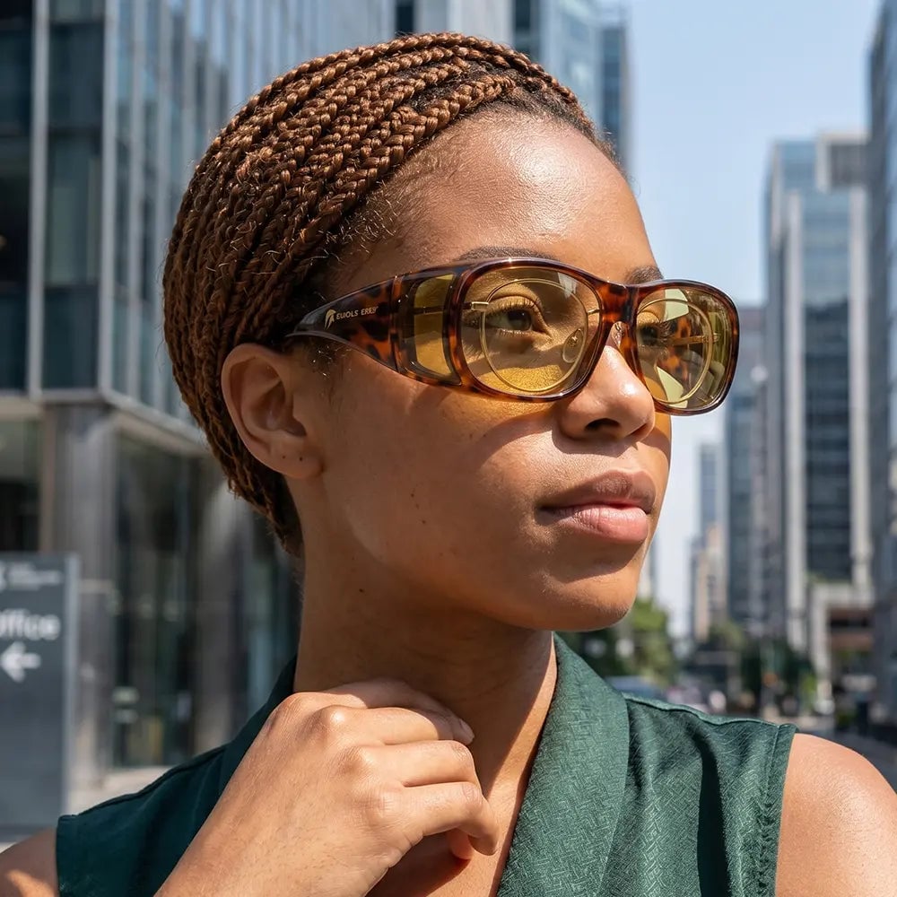 Mujer usando lentes EagleEyes NightLite Fit On Tortoise sobre sus lentes