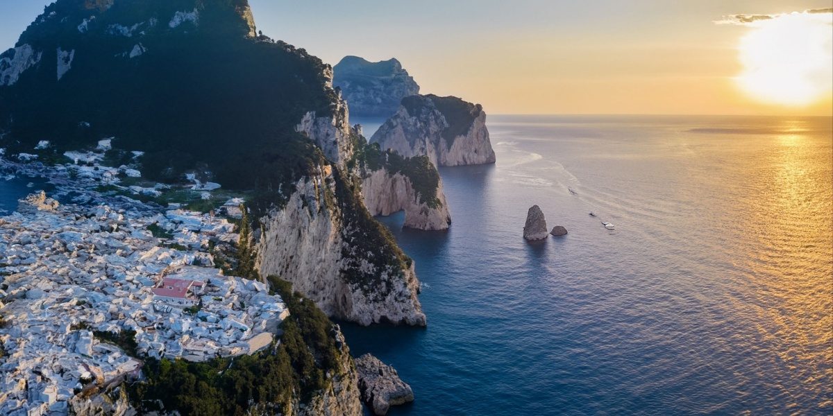Capri coast and Faraglioni rocks at sunset