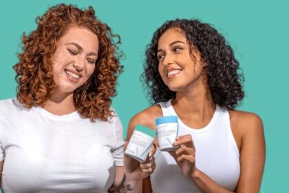 Two women holding Happy V wellness products