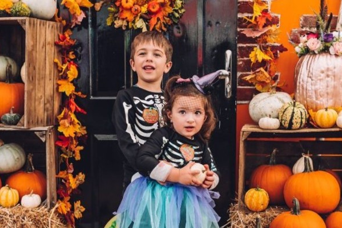 Siblings enjoying a seasonal pumpkin patch visit