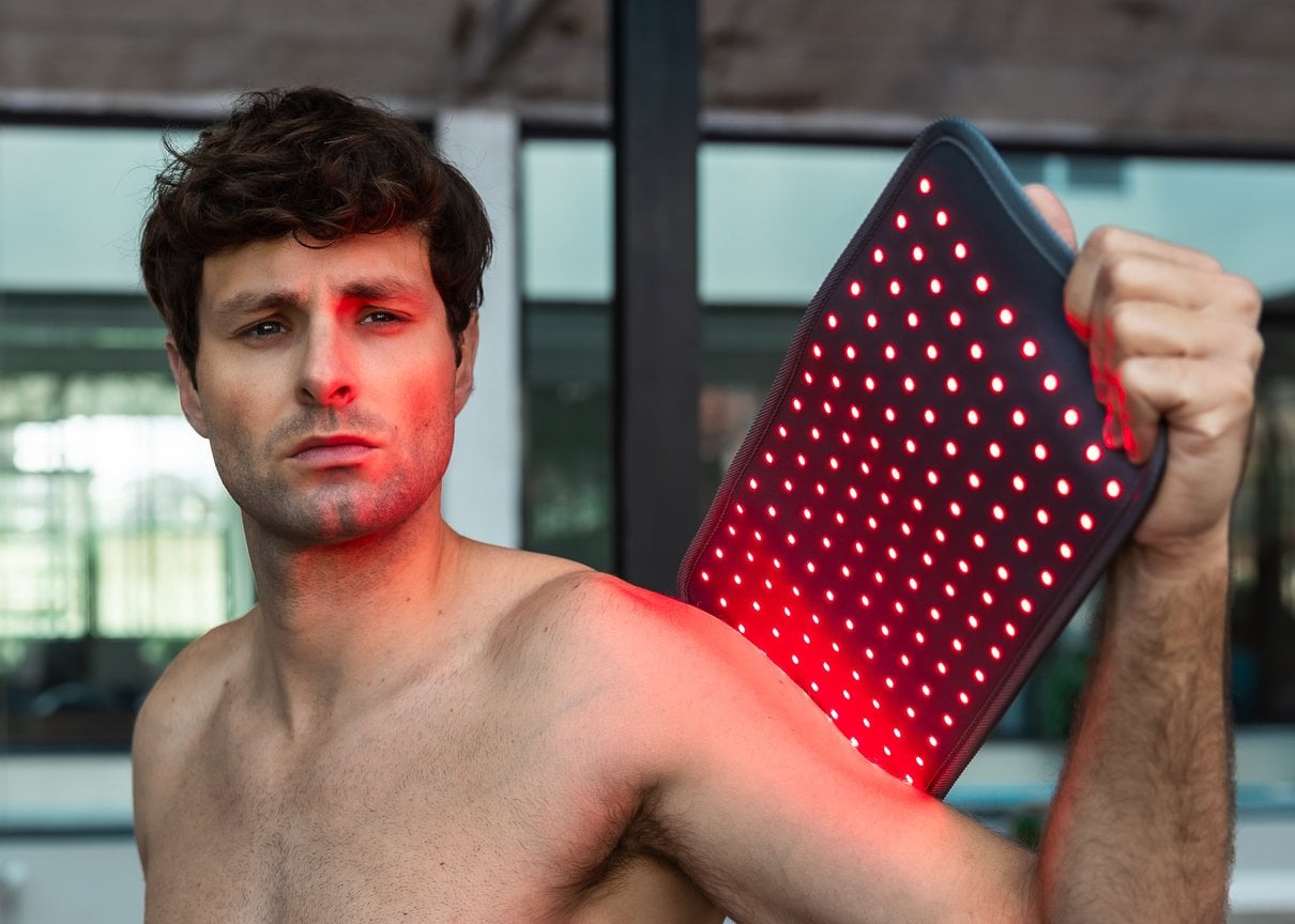 Person using the NOVAALAB LLC Light Pad on a shoulder