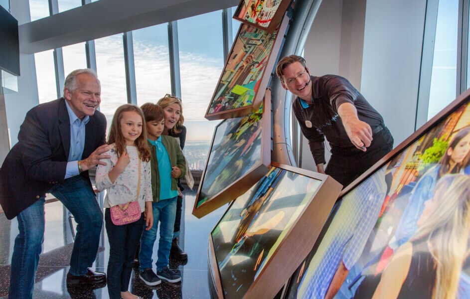 Family exploring an interactive exhibit at One World Observatory