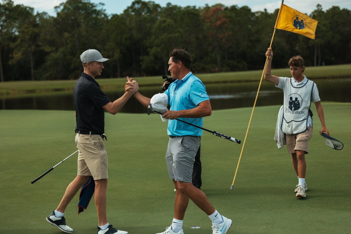 Golfers shaking hands on a green