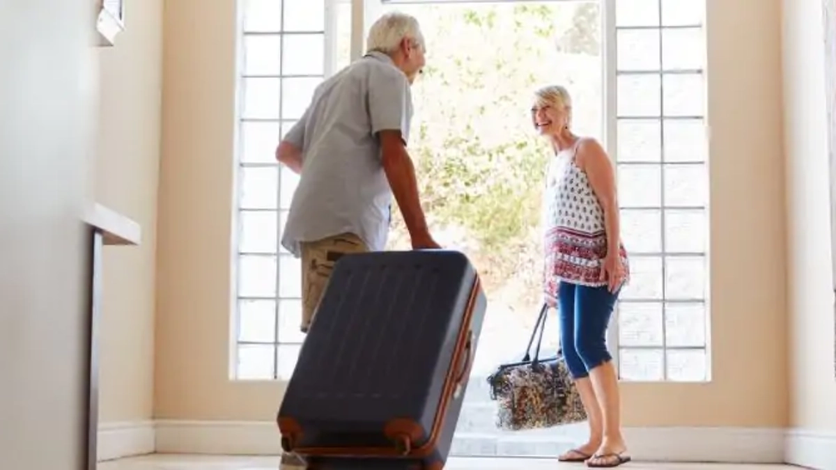 Older couple leaving for a holiday with suitcases