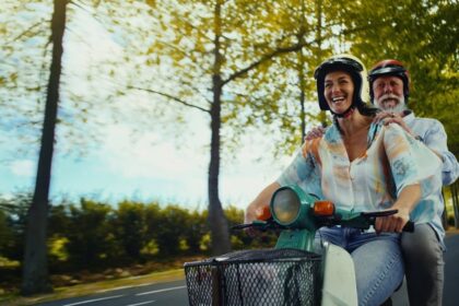 Traveller riding a moped on holiday, representing Staysure travel insurance