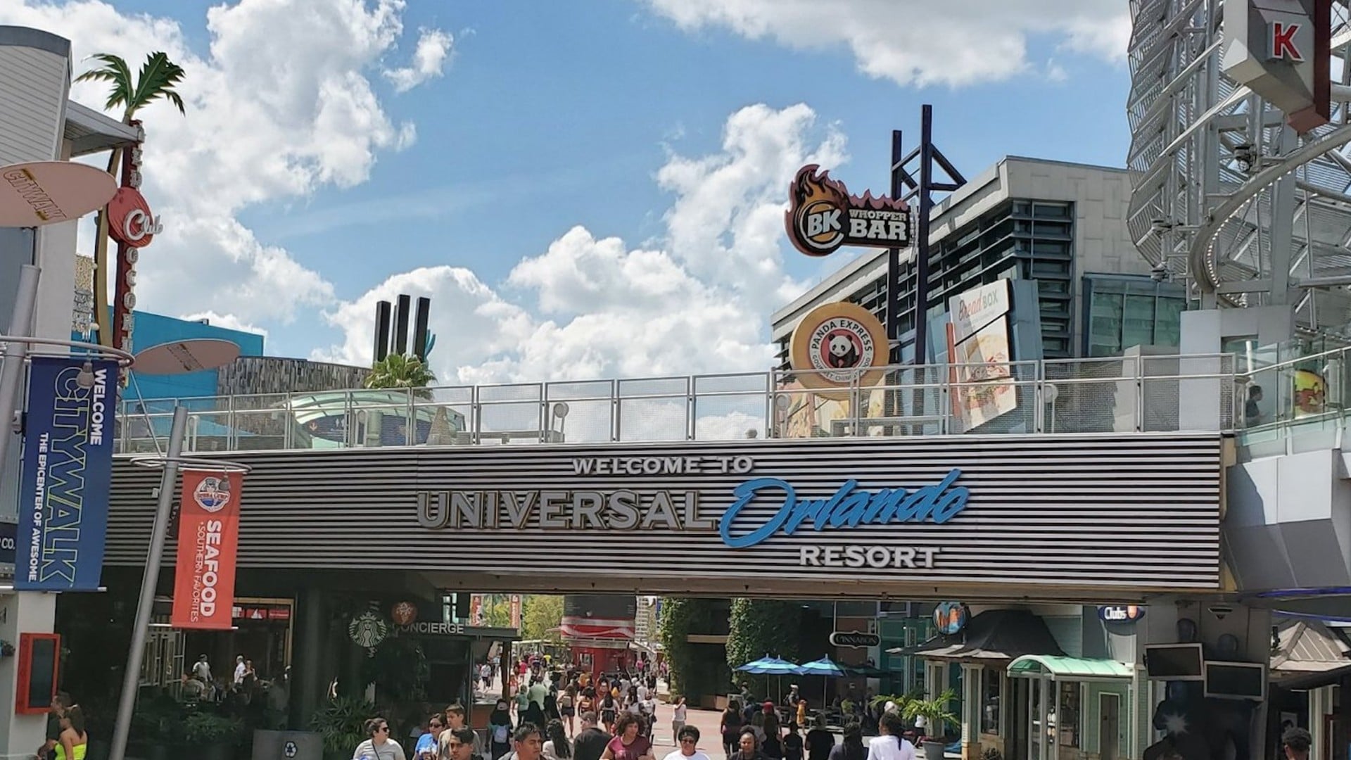 Visitors walking through the Universal Orlando CityWalk promenade