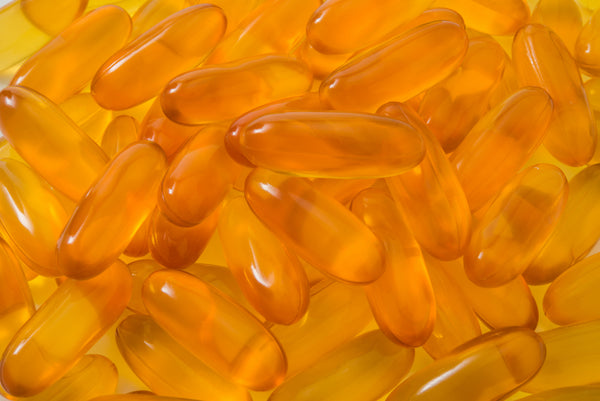 Close-up of amber supplement capsules