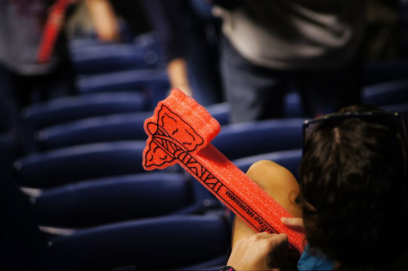 Atlanta Braves fan holding a tomahawk at a baseball game
