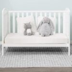Alice cot bed shown in a softly styled nursery