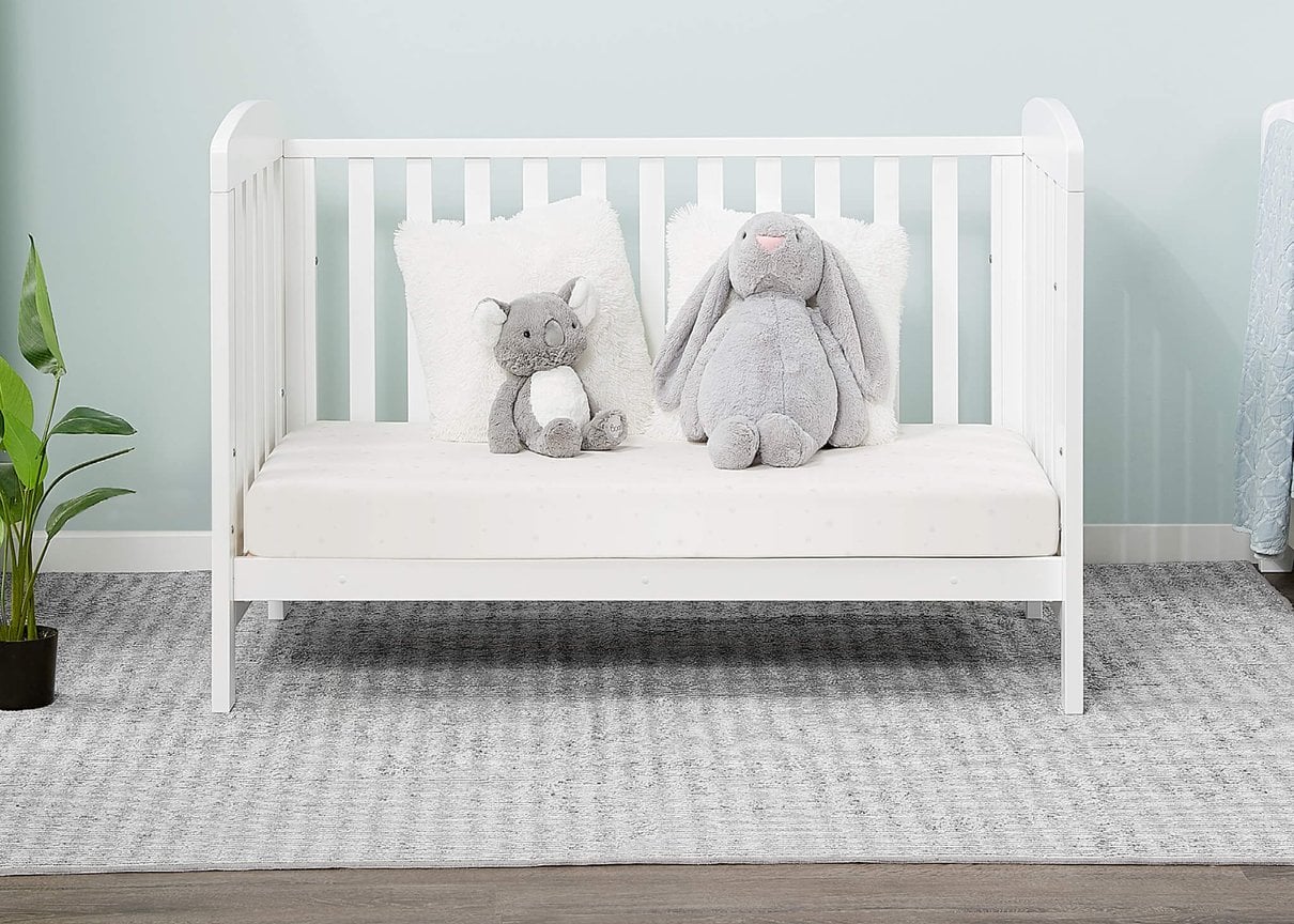 Alice cot bed shown in a softly styled nursery