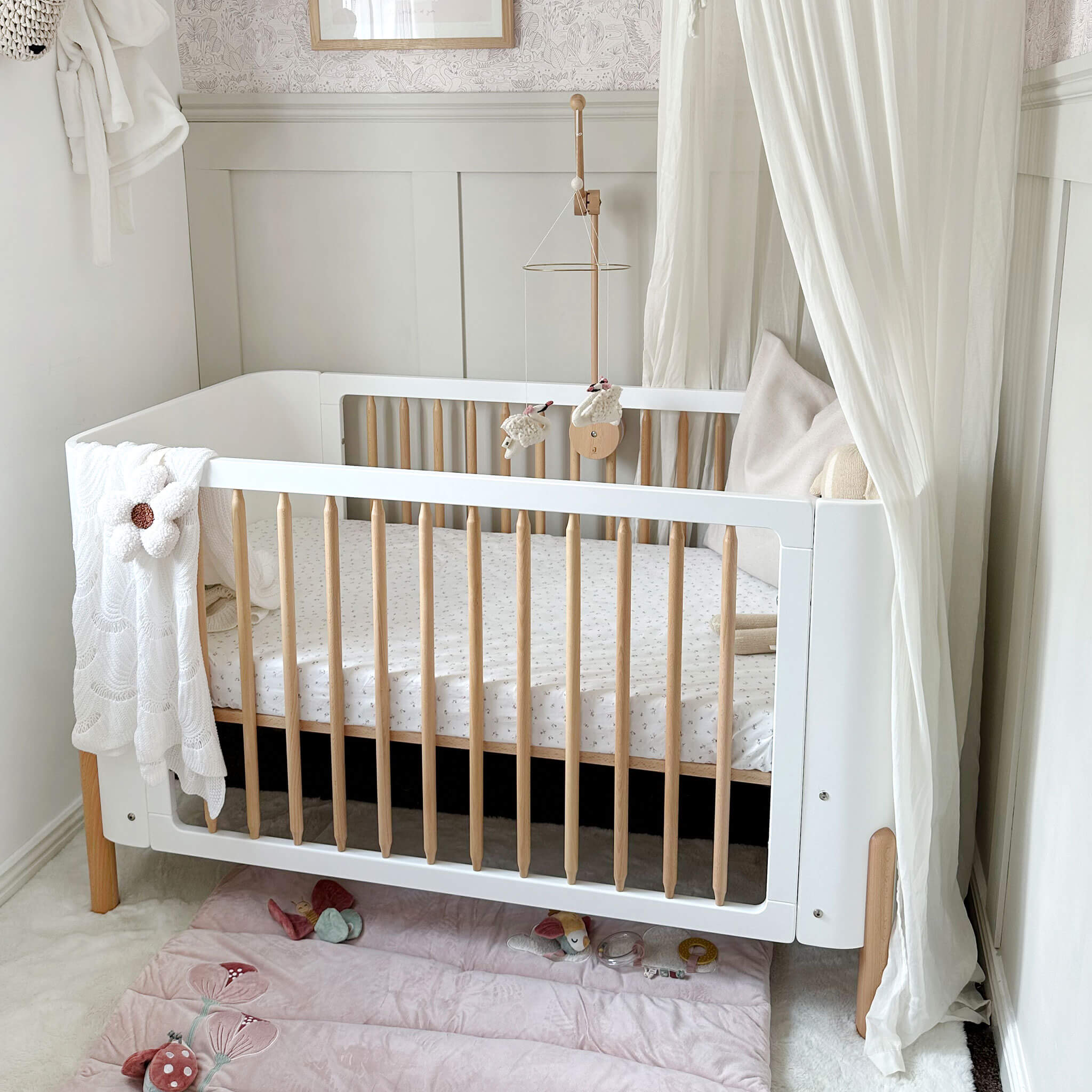Nova cot bed in a nursery setting