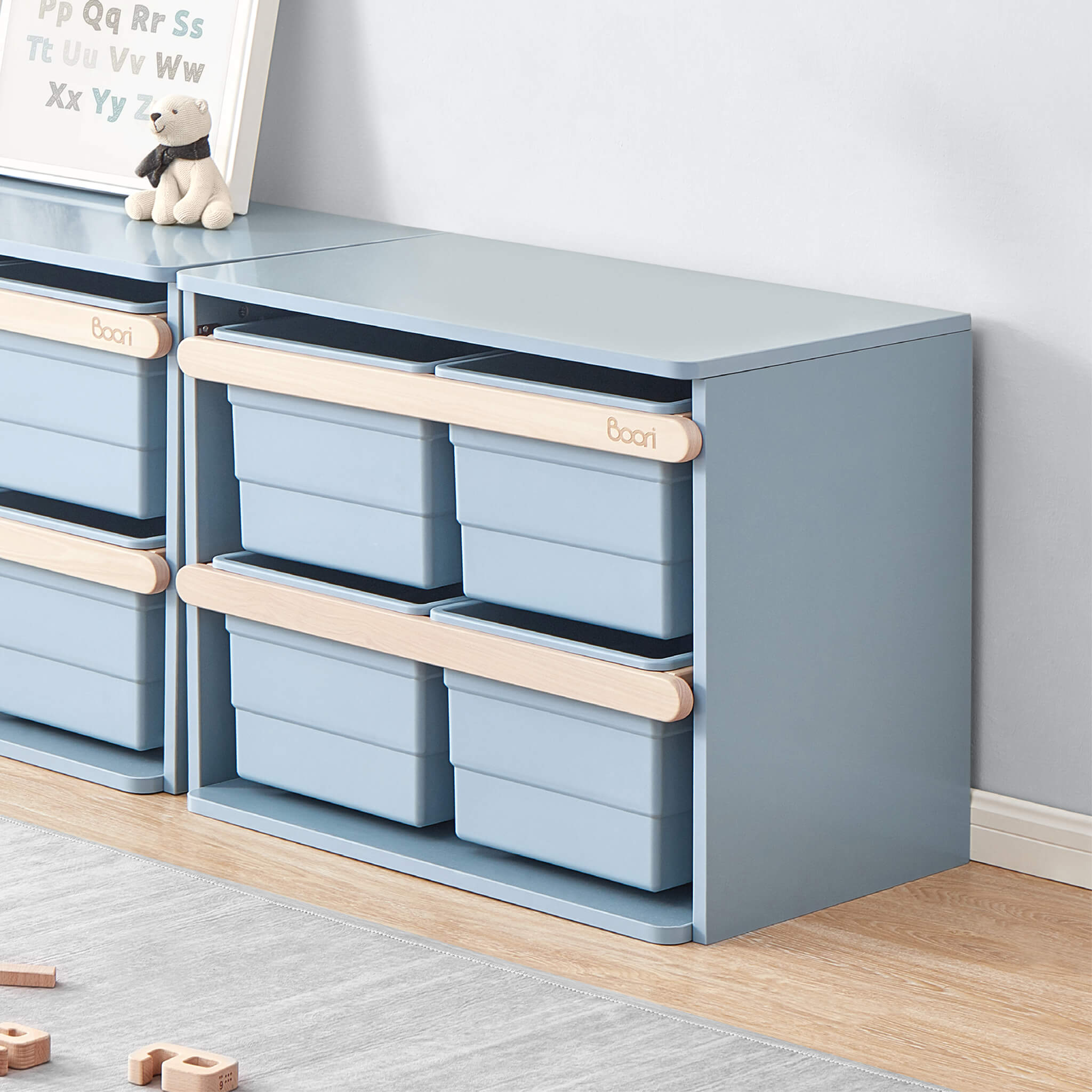 Tidy toy cabinet with storage tubs in a playroom