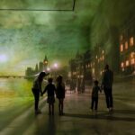 Family standing inside The World Around Us Gallery at Frameless