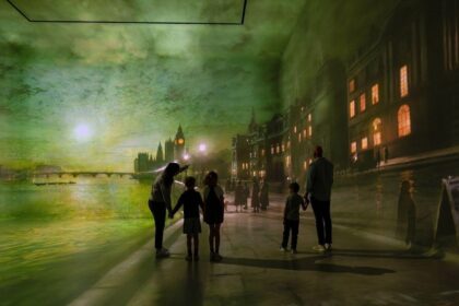 Family standing inside The World Around Us Gallery at Frameless