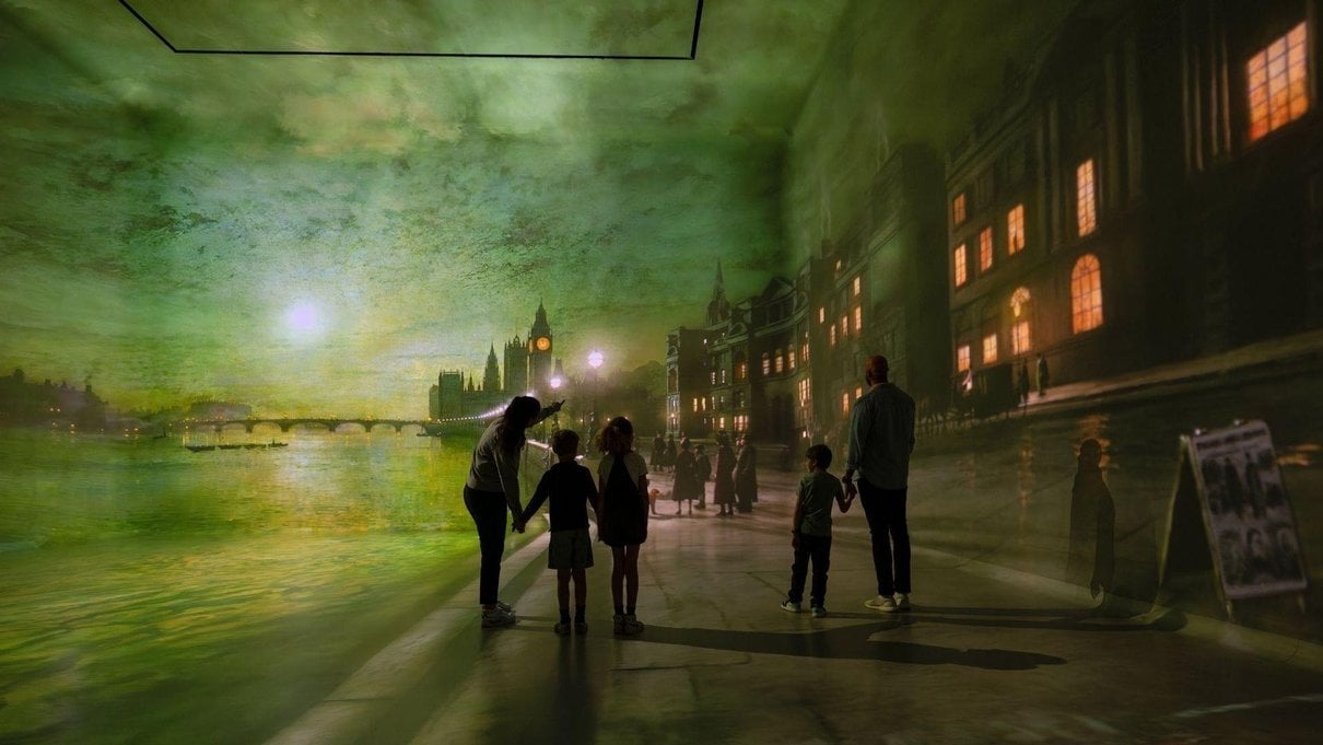 Family standing inside The World Around Us Gallery at Frameless