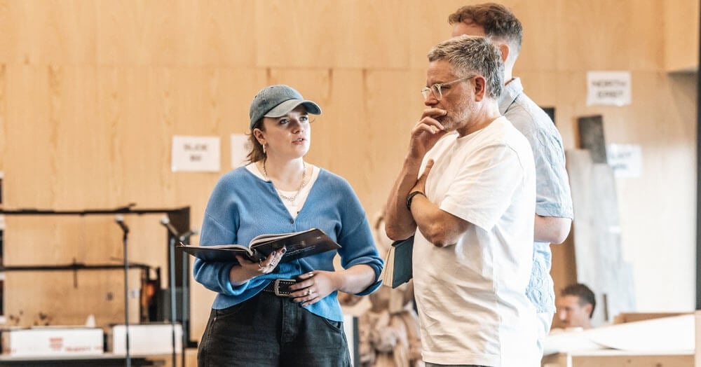A performer and director discussing a scene during rehearsal