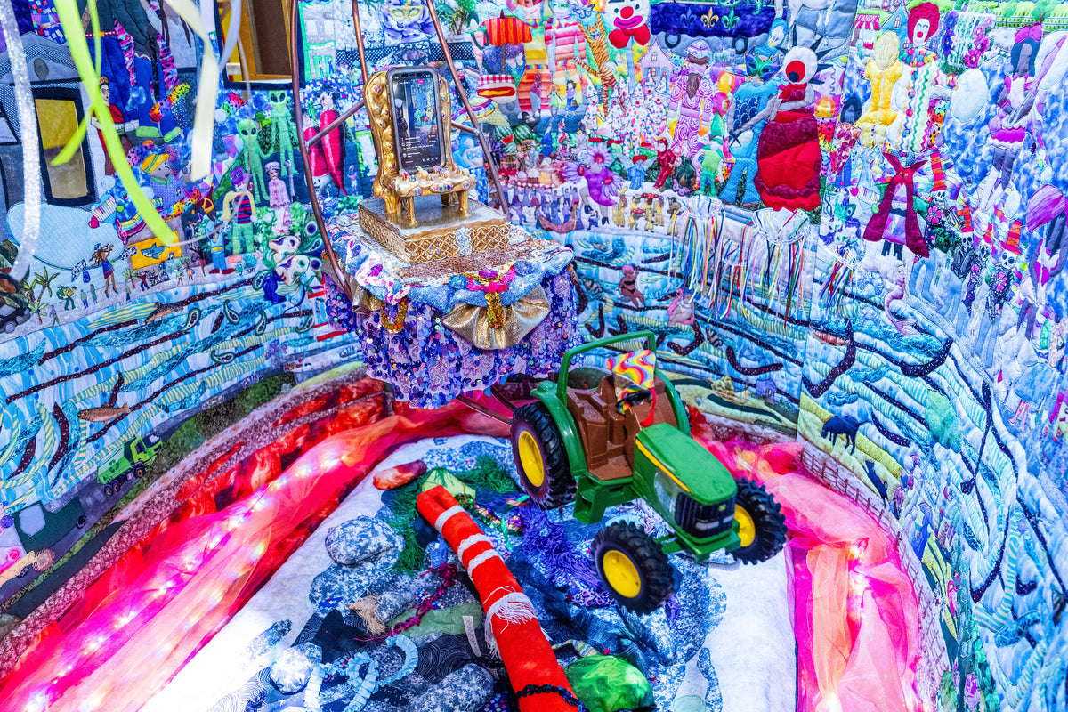 Quilted Mardi Gras day scene by Jane Tardo with a toy green truck at JAMNOLA