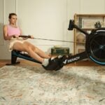 Merach R50 air resistance rowing machine in a home workout setting