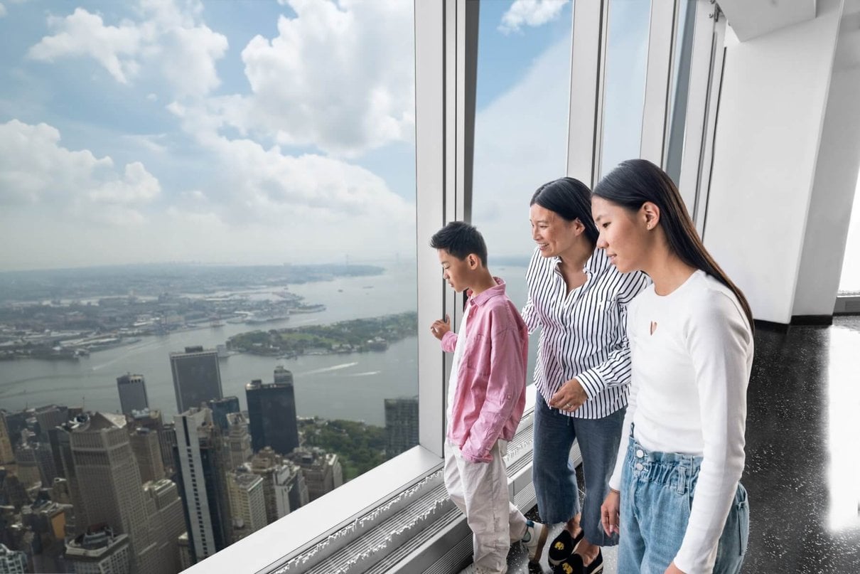 Visitors looking across the New York skyline from One World Observatory