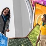 A guide and visitor at an interactive exhibit in One World Observatory