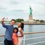 Family viewing the Statue of Liberty from One World Observatory