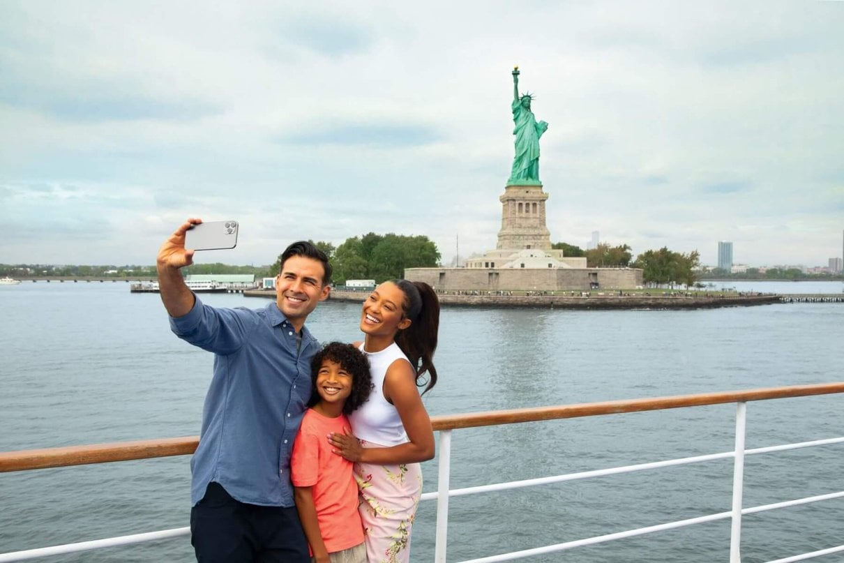 Family viewing the Statue of Liberty from One World Observatory