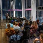 Audience attending an indoor evening talk at The View from The Shard