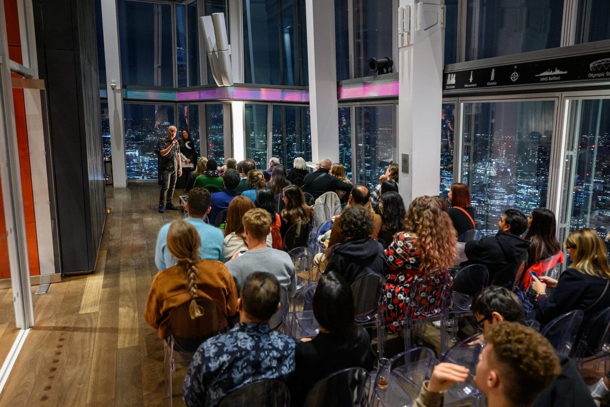 Audience attending an indoor evening talk at The View from The Shard