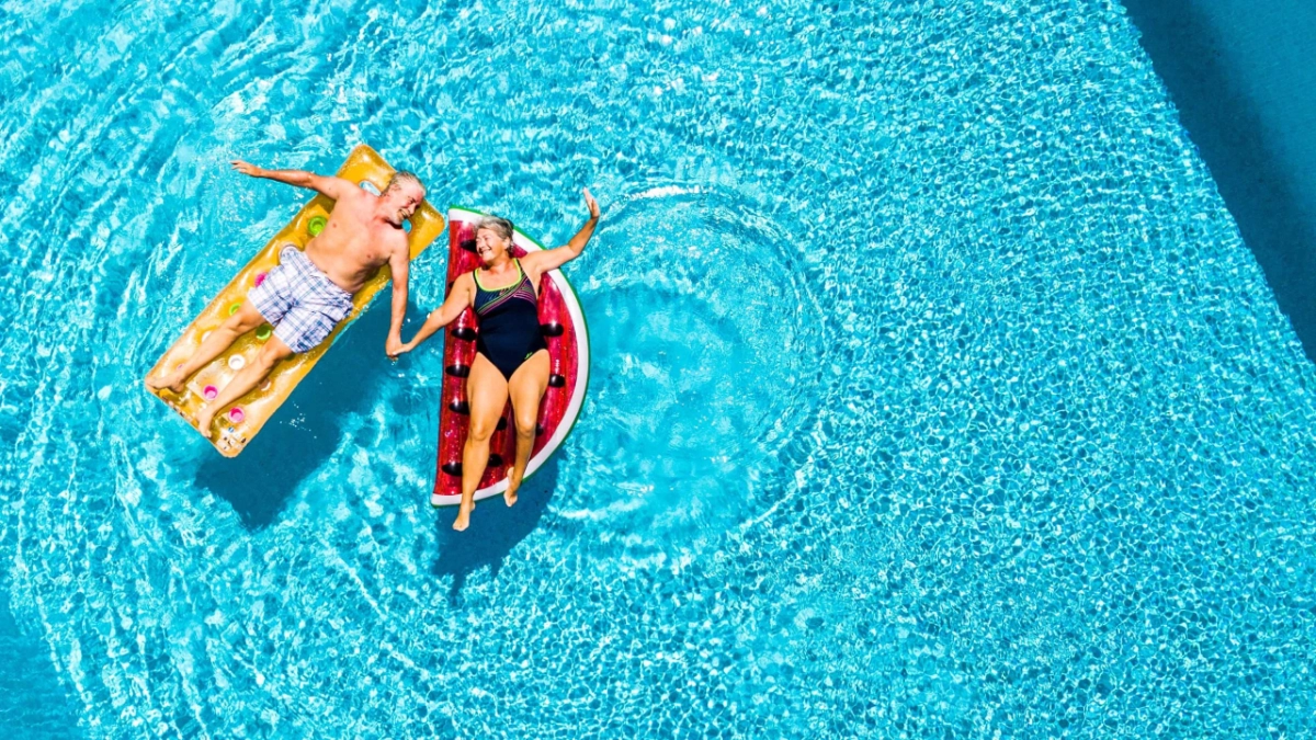 A mature couple relaxing together in a swimming pool