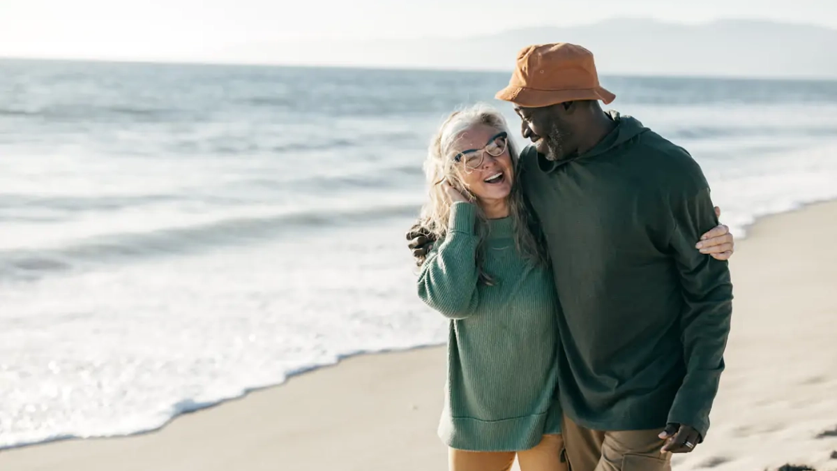 Older couple enjoying a walk on the beach