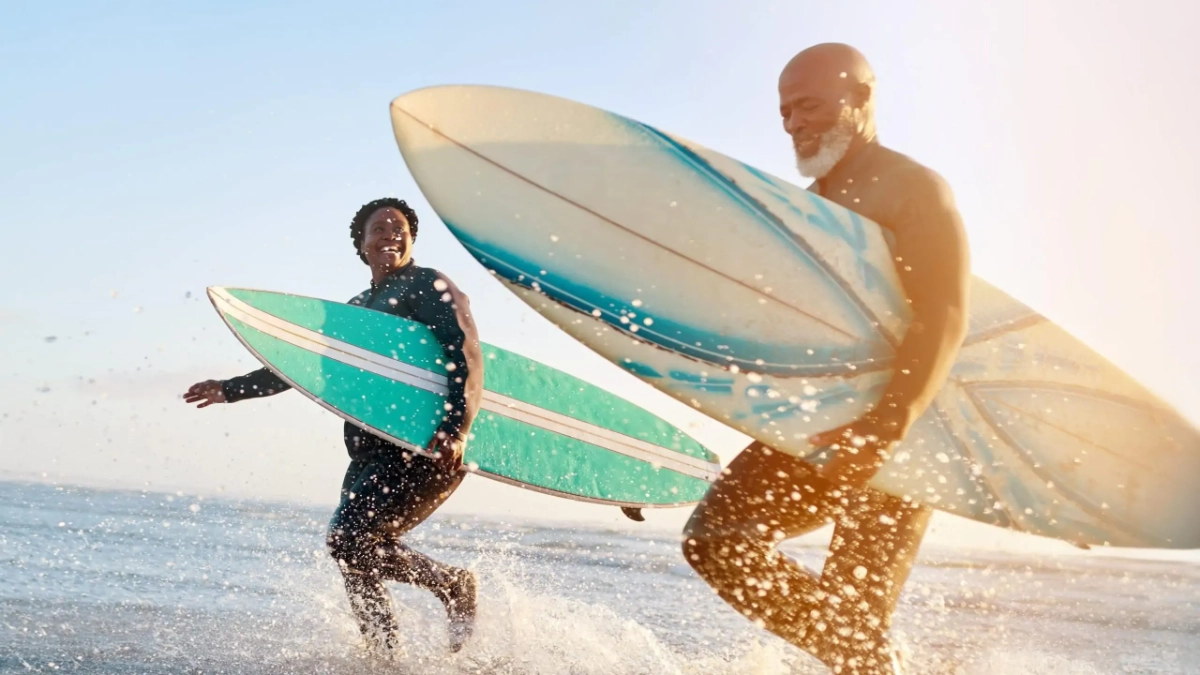 Mature couple surfing at the beach