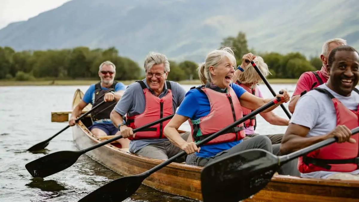Friends rowing together on a river