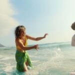 Travellers standing in the sea on a sunny holiday