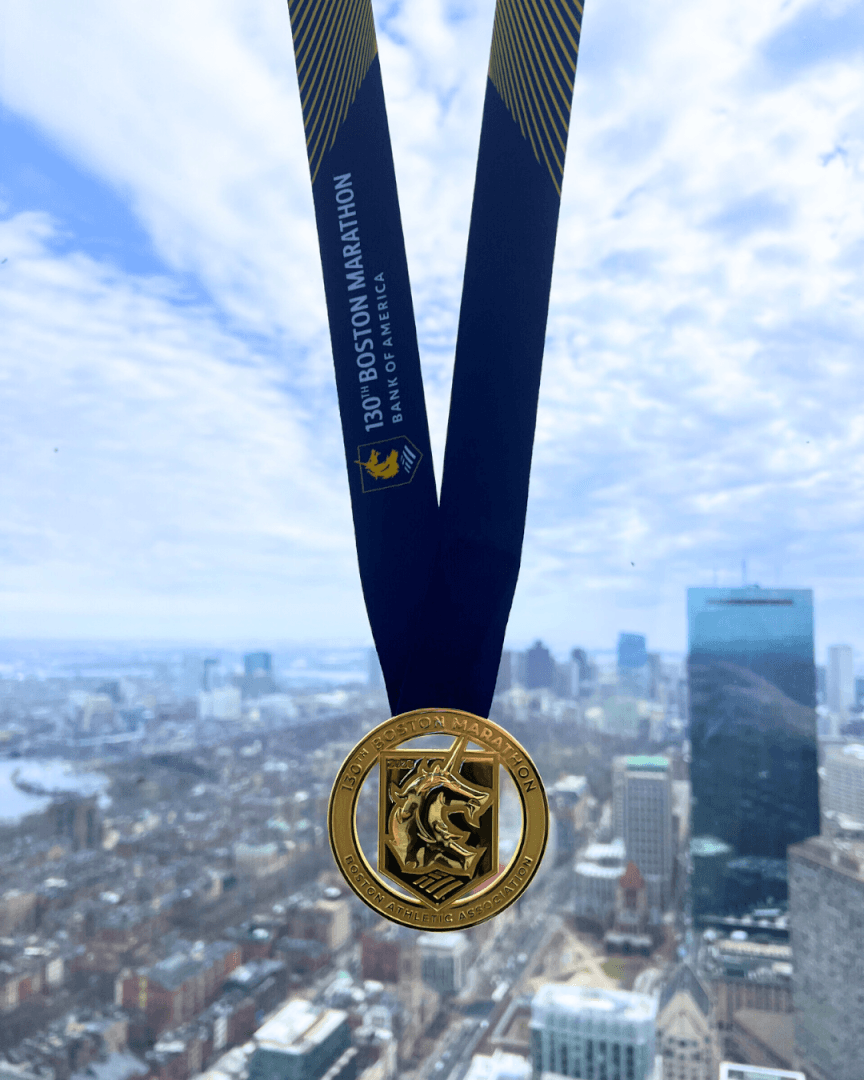 A Boston Marathon medal displayed against the skyline