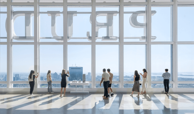 Guests looking through the windows inside the View Boston observatory